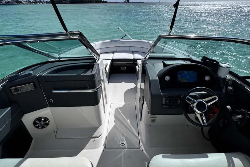  Yacht Photos Pics 2018 Regal 29 OBX boat interior with steering wheel, dashboard, and open water view.