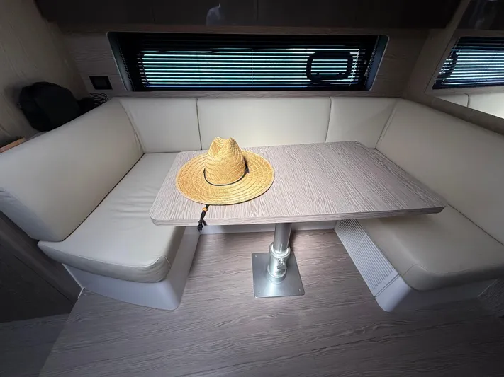 Relax Josephine Yacht Photos Pics Interior of 2022 Azimut Atlantis 45 yacht with a straw hat on the table.