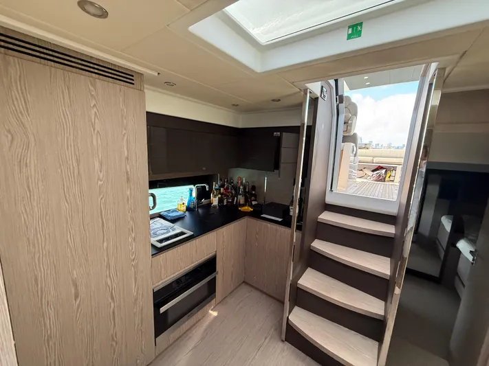 Relax Josephine Yacht Photos Pics Modern kitchen interior of 2022 Azimut Atlantis 45 yacht with wooden cabinetry and skylight.