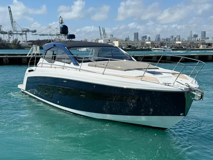 Relax Josephine Yacht Photos Pics Azimut Atlantis 45 yacht, 2022 model, cruising in a marina with city skyline background.