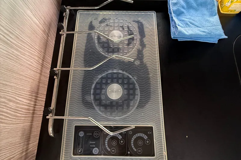 Relax Josephine Yacht Photos Pics Modern stovetop on Azimut Atlantis 45 yacht, 2022 model, with control panel and cleaning cloth.