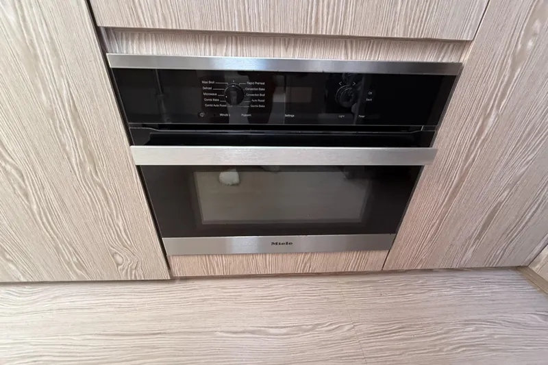 Relax Josephine Yacht Photos Pics Built-in oven in Azimut Atlantis 45 yacht, 2022 model, with sleek wood paneling.