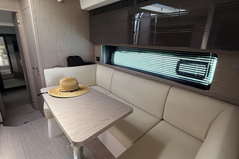 Relax Josephine Yacht Photos Pics Interior of 2022 Azimut Atlantis 45 yacht with beige seating and table.