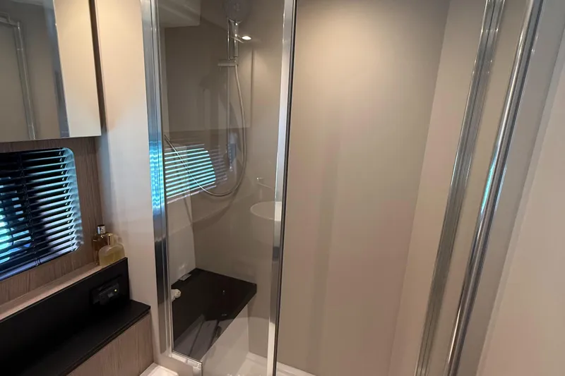 Relax Josephine Yacht Photos Pics Modern bathroom interior of 2022 Azimut Atlantis 45 yacht with glass shower enclosure.