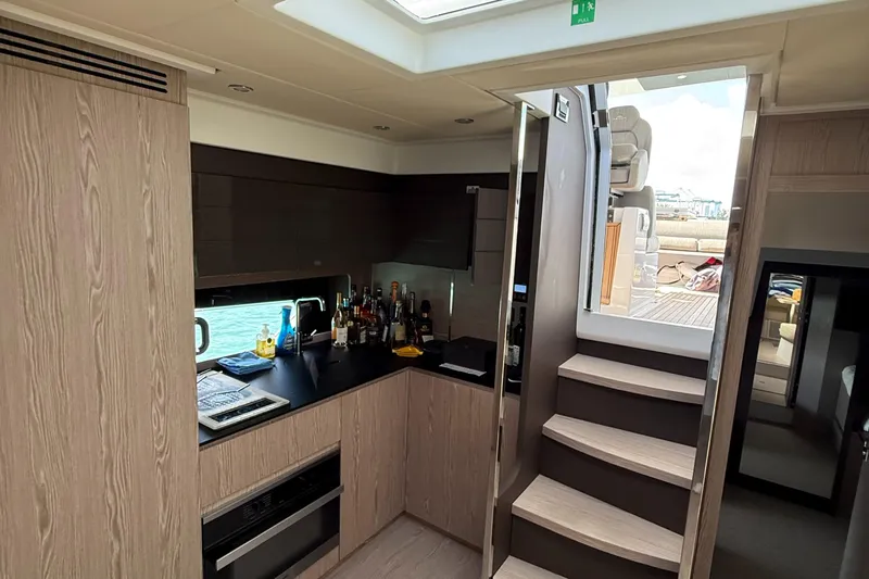 Relax Josephine Yacht Photos Pics Interior of 2022 Azimut Atlantis 45 yacht, featuring modern kitchen and staircase.