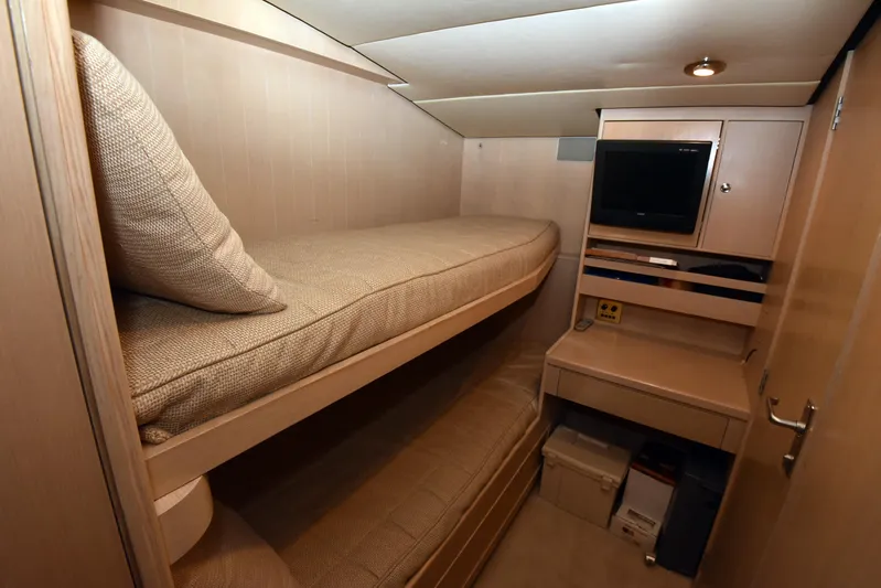 Talisman Yacht Photos Pics Interior of 1989 Striker 62 Convertible yacht with bunk beds and TV.