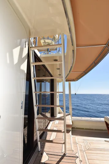 Talisman Yacht Photos Pics Striker 62 Convertible Yacht, 1989, with ocean view and sunshade.