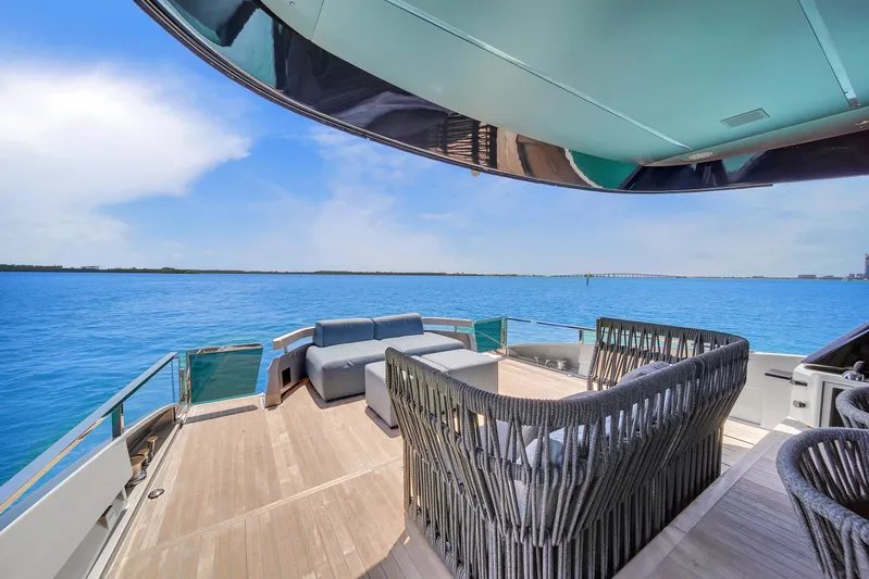  Yacht Photos Pics Luxurious Explorer 62 yacht deck with modern seating, overlooking serene blue waters, 2021 model.