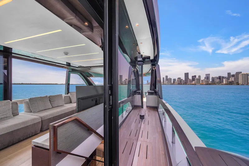 Yacht Photos Pics Luxurious 2021 Explorer 62 yacht with modern interior, overlooking a vibrant city skyline.