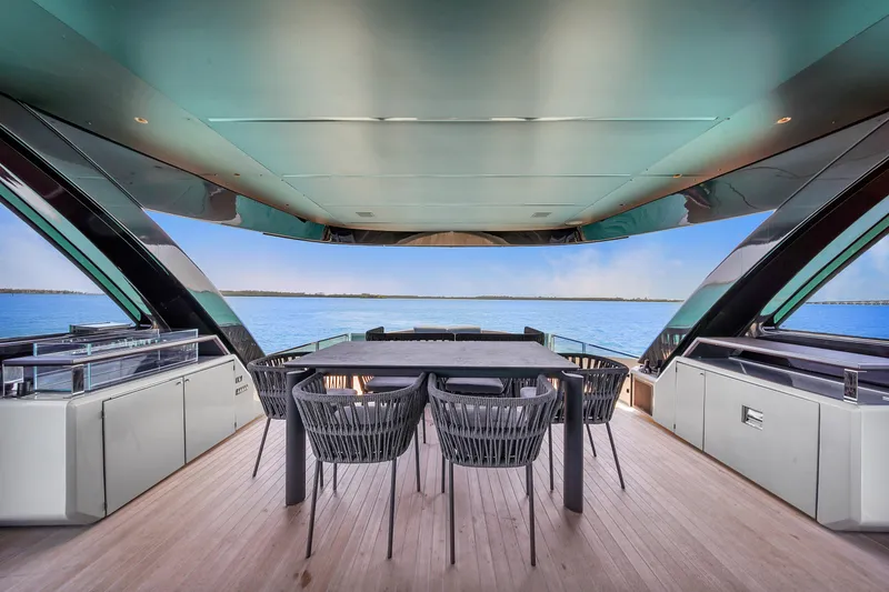  Yacht Photos Pics Luxurious Explorer 62 yacht deck with dining area, overlooking serene ocean view, 2021 model.