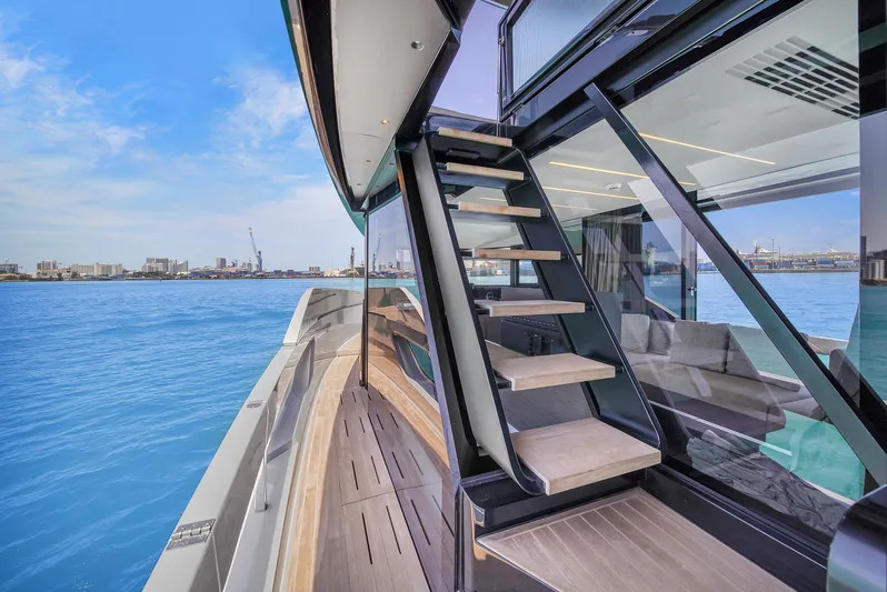  Yacht Photos Pics Modern Explorer 62 yacht deck with stairs, overlooking serene blue waters, 2021 model.