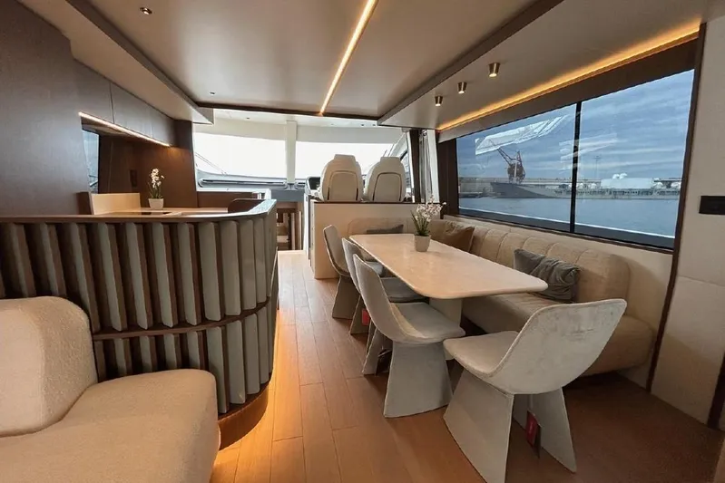  Yacht Photos Pics Luxurious interior of 2024 Azimut Fly 72 yacht with elegant dining area and panoramic windows.