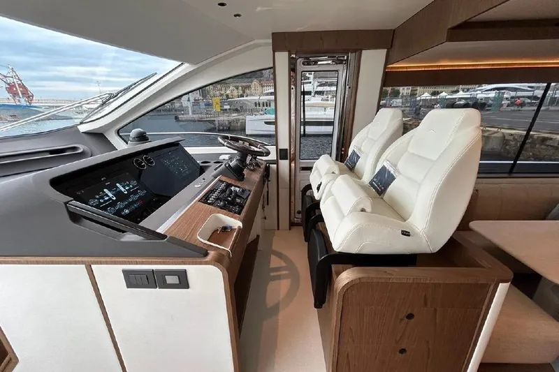  Yacht Photos Pics Luxurious interior of 2024 Azimut Fly 72 yacht with modern dashboard and plush seating.