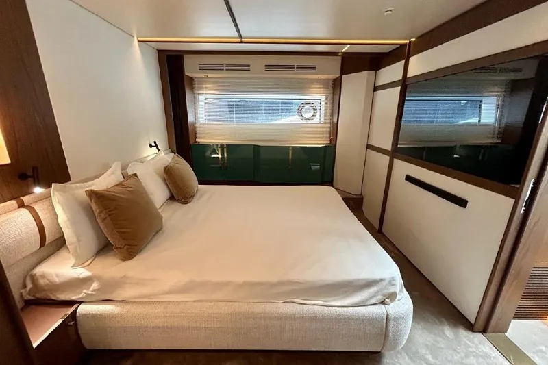  Yacht Photos Pics Luxurious bedroom interior of 2024 Azimut Fly 72 yacht, featuring modern design and cozy bedding.