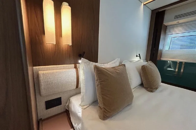  Yacht Photos Pics Luxurious bedroom interior of 2024 Azimut Fly 72 yacht with elegant lighting and plush bedding.
