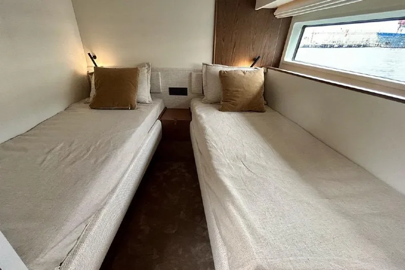  Yacht Photos Pics Interior of 2024 Azimut Fly 72 yacht with twin beds and window view.