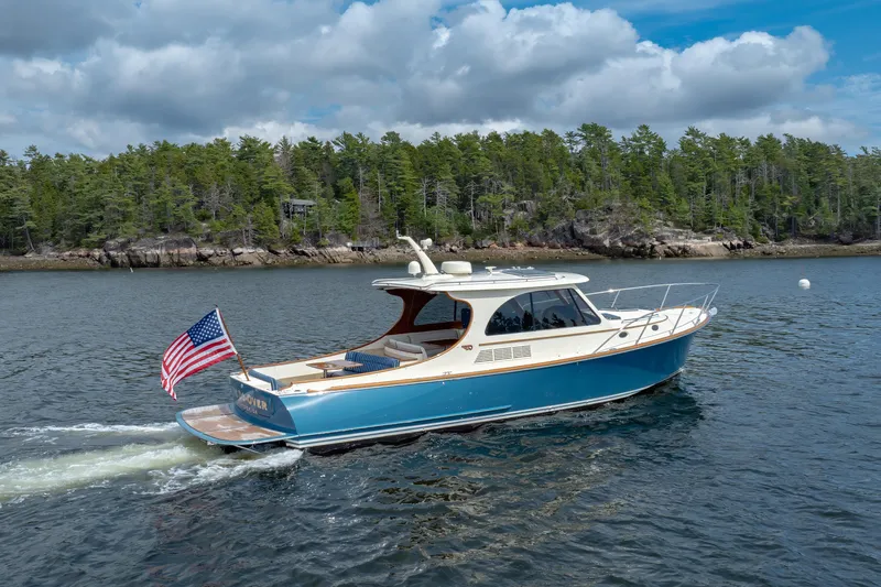 The Do-over Yacht Photos Pics 2024 Hinckley Picnic Boat 40 cruising on a scenic lake with forested shoreline.