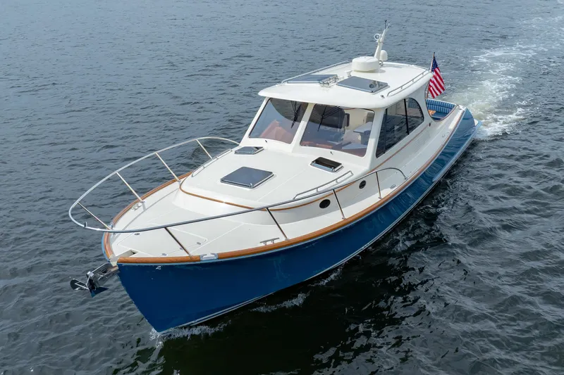 The Do-over Yacht Photos Pics 2024 Hinckley Picnic Boat 40 cruising on open water, showcasing elegant design and craftsmanship.