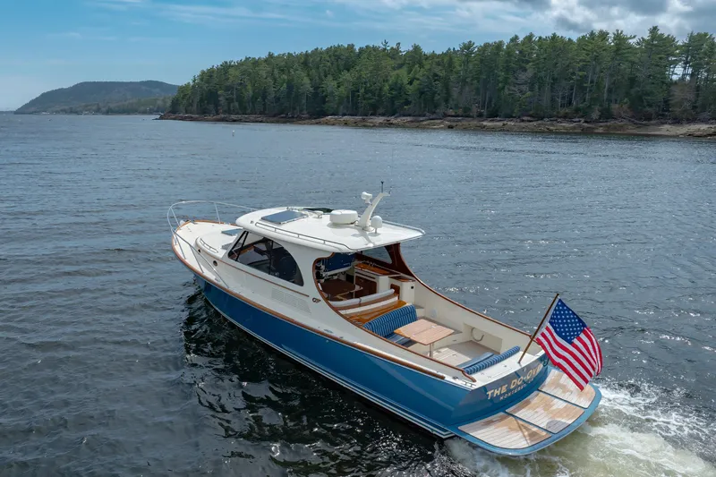 The Do-over Yacht Photos Pics 2024 Hinckley Picnic Boat 40 cruising on a scenic lake with forested shoreline.