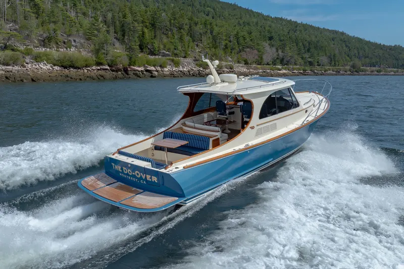 The Do-over Yacht Photos Pics 2024 Hinckley Picnic Boat 40 cruising on a scenic lake with lush green shoreline.