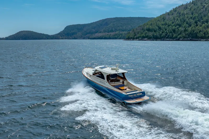 The Do-over Yacht Photos Pics 2024 Hinckley Picnic Boat 40 cruising on a scenic lake with forested hills.