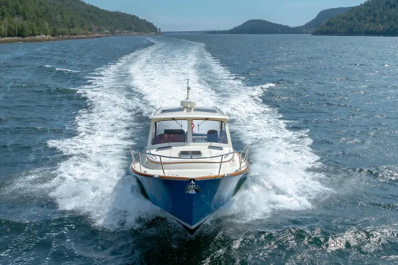 The Do-over Yacht Photos Pics 2024 Hinckley Picnic Boat 40 cruising on open water, surrounded by scenic landscape.