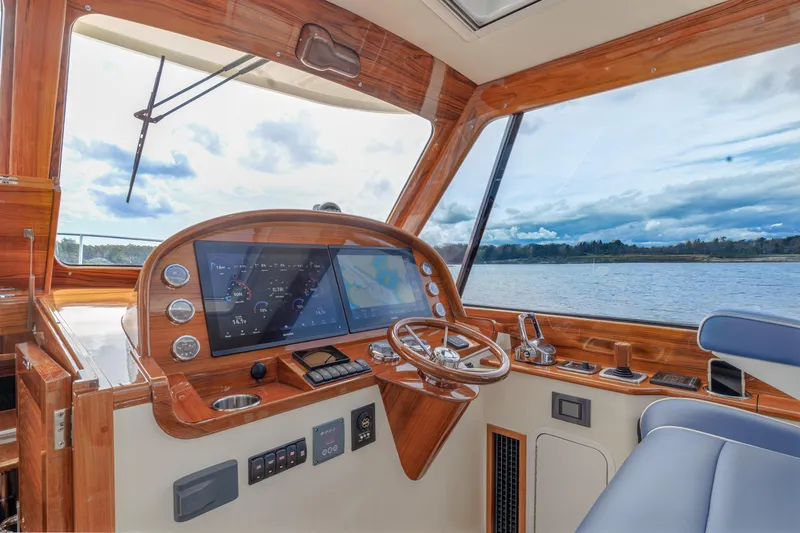 The Do-over Yacht Photos Pics 2024 Hinckley Picnic Boat 40 helm with wooden dashboard and scenic water view.