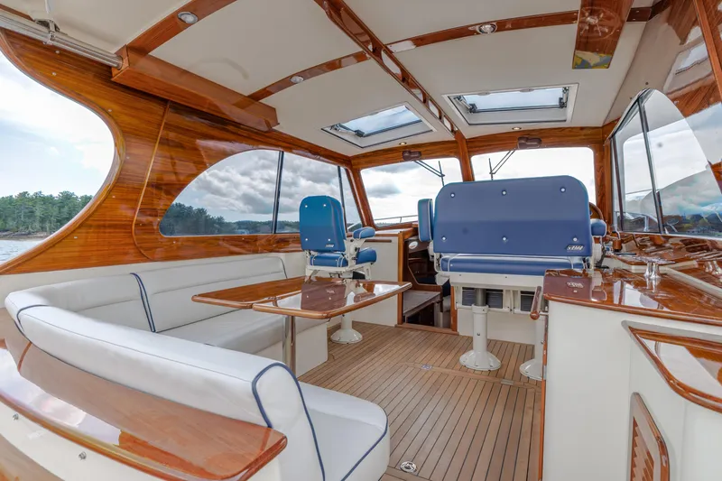 The Do-over Yacht Photos Pics 2024 Hinckley Picnic Boat 40 interior with elegant wood finish and blue seating.