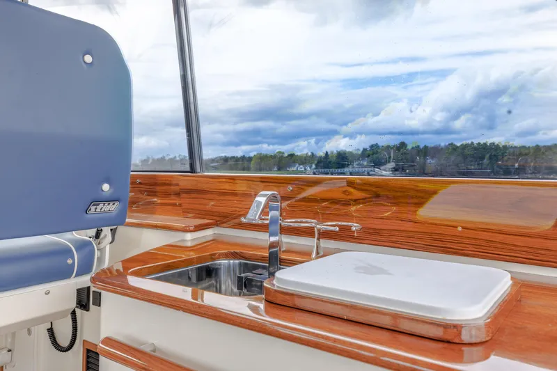 The Do-over Yacht Photos Pics 2024 Hinckley Picnic Boat 40 interior with sleek wood finish and modern sink.