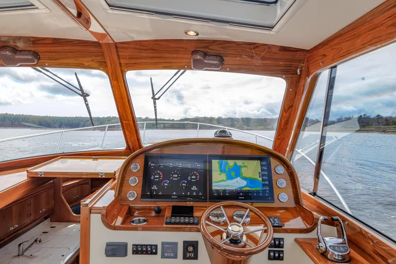 The Do-over Yacht Photos Pics 2024 Hinckley Picnic Boat 40 helm with navigation display and wooden accents.