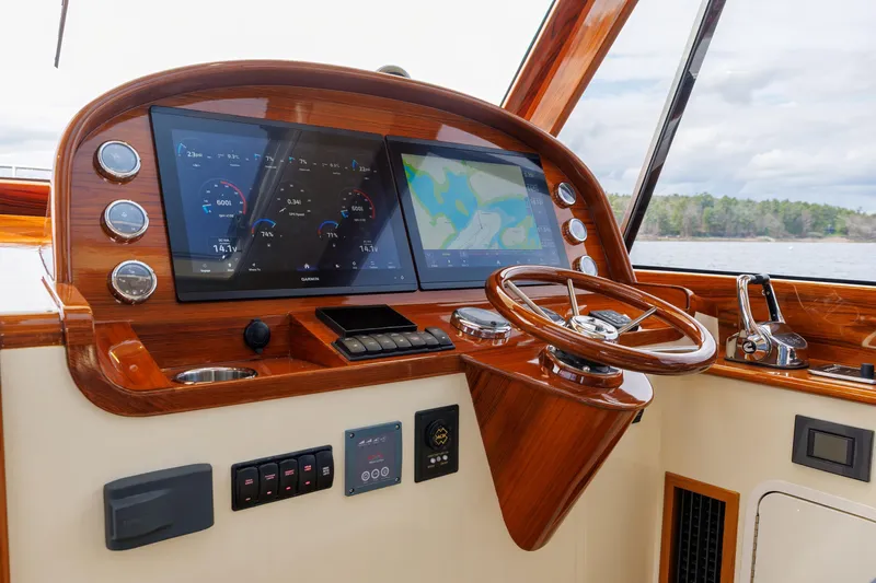 The Do-over Yacht Photos Pics 2024 Hinckley Picnic Boat 40 helm with modern navigation displays and wooden steering wheel.