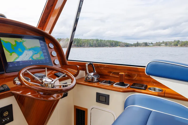 The Do-over Yacht Photos Pics 2024 Hinckley Picnic Boat 40 interior with wooden helm and navigation display.