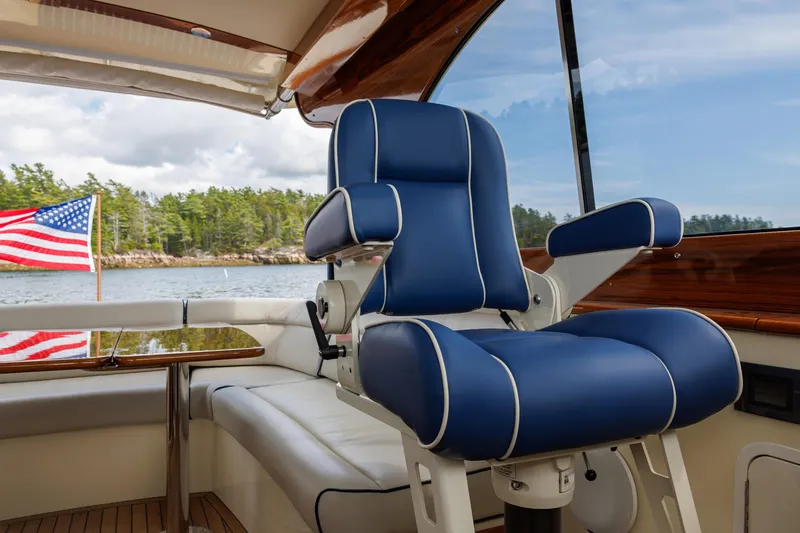 The Do-over Yacht Photos Pics 2024 Hinckley Picnic Boat 40 interior with blue captain's chair and American flag.
