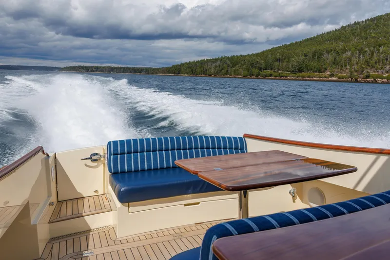 The Do-over Yacht Photos Pics 2024 Hinckley Picnic Boat 40 cruising on water, featuring elegant seating and wooden table.