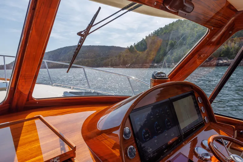 The Do-over Yacht Photos Pics 2024 Hinckley Picnic Boat 40 helm with scenic water and forest view.