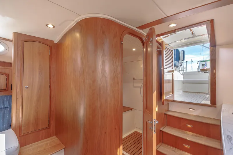 The Do-over Yacht Photos Pics 2024 Hinckley Picnic Boat 40 interior with wooden cabinetry and steps leading to deck.