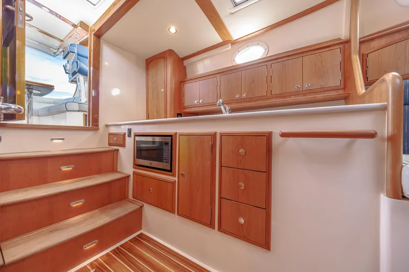 The Do-over Yacht Photos Pics 2024 Hinckley Picnic Boat 40 interior with wooden cabinetry and modern kitchen amenities.
