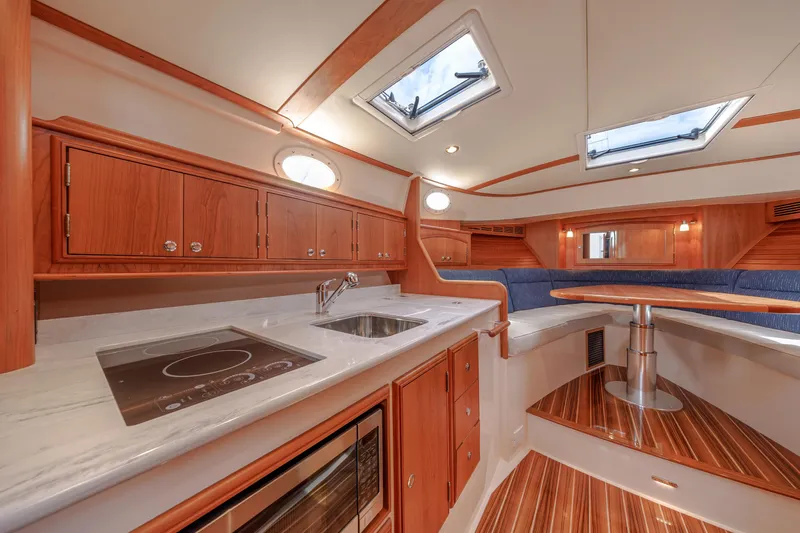 The Do-over Yacht Photos Pics 2024 Hinckley Picnic Boat 40 interior with modern kitchen and seating area.