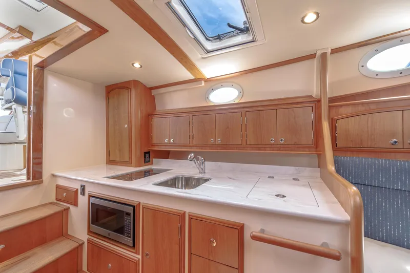 The Do-over Yacht Photos Pics 2024 Hinckley Picnic Boat 40 interior kitchen with wood cabinetry and modern appliances.