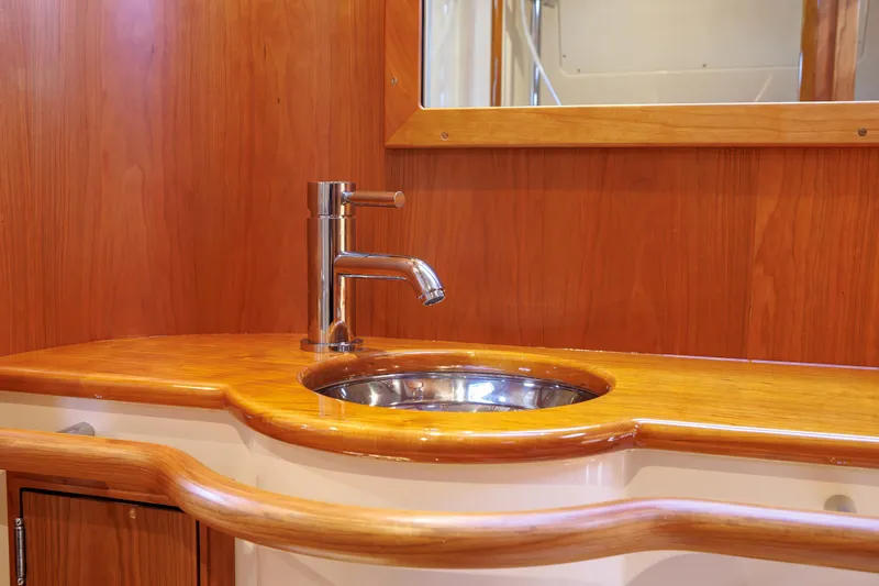 The Do-over Yacht Photos Pics 2024 Hinckley Picnic Boat 40 interior with wooden vanity and modern sink.