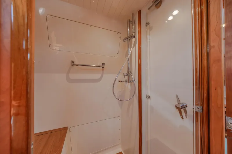 The Do-over Yacht Photos Pics 2024 Hinckley Picnic Boat 40 shower area with wooden accents and modern fixtures.