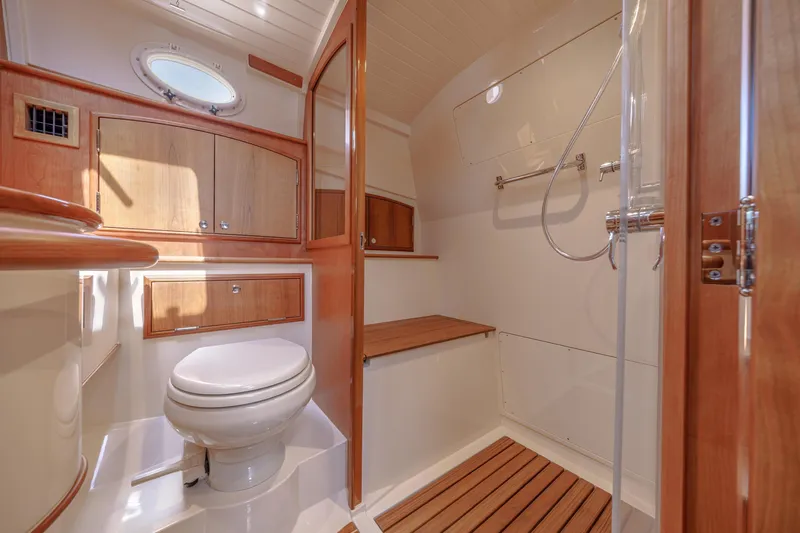 The Do-over Yacht Photos Pics Luxurious bathroom in 2024 Hinckley Picnic Boat 40, featuring wood accents and modern fixtures.