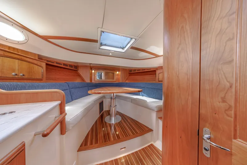 The Do-over Yacht Photos Pics 2024 Hinckley Picnic Boat 40 interior with elegant wood finish and cozy seating area.