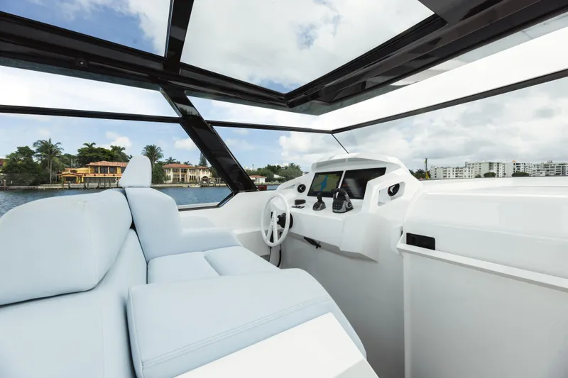 Shir Yacht Photos Pics 2024 Vanquish 58 yacht interior with modern helm and luxurious seating.