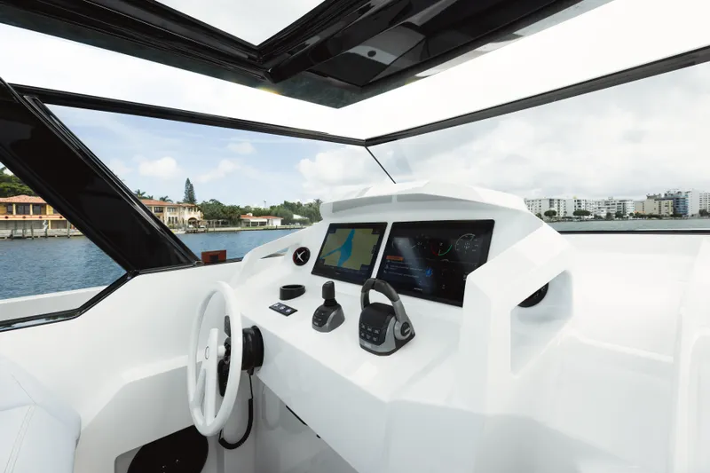 Shir Yacht Photos Pics 2024 Vanquish 58 yacht cockpit with modern navigation displays and sleek design.