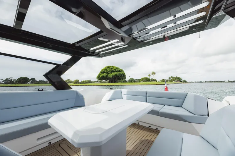 Shir Yacht Photos Pics Luxurious 2024 Vanquish 58 yacht interior with sleek seating and scenic water view.