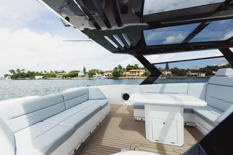 Shir Yacht Photos Pics Luxurious 2024 Vanquish 58 yacht interior with sleek seating and waterfront view.