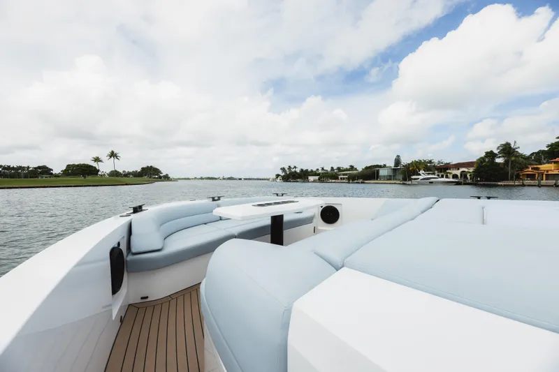 Shir Yacht Photos Pics Luxurious 2024 Vanquish 58 yacht interior with elegant seating and scenic waterfront view.