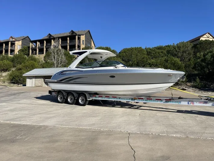 Only A Formula Yacht Photos Pics 2025 Formula 310 Bowrider on trailer, parked outdoors with buildings in the background.