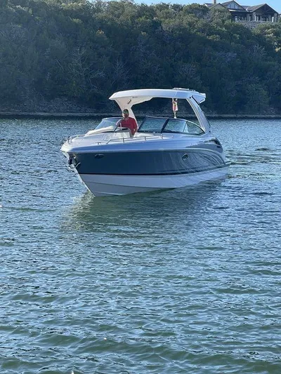 Only A Formula Yacht Photos Pics 2025 Formula 310 Bowrider cruising on a serene lake with lush greenery.